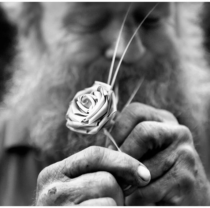 image of a man making a palm rose